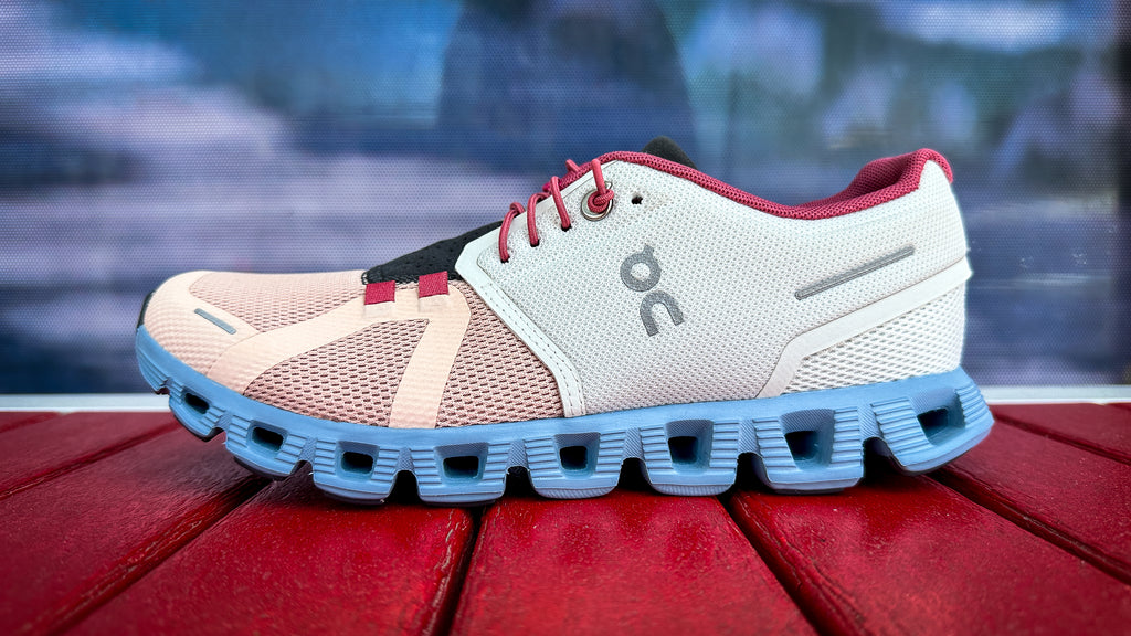 Photo of Women's On Cloud 5 sitting on red bench in front of Waco Running Company